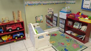 View of nursery classroom with small furniture for infants.